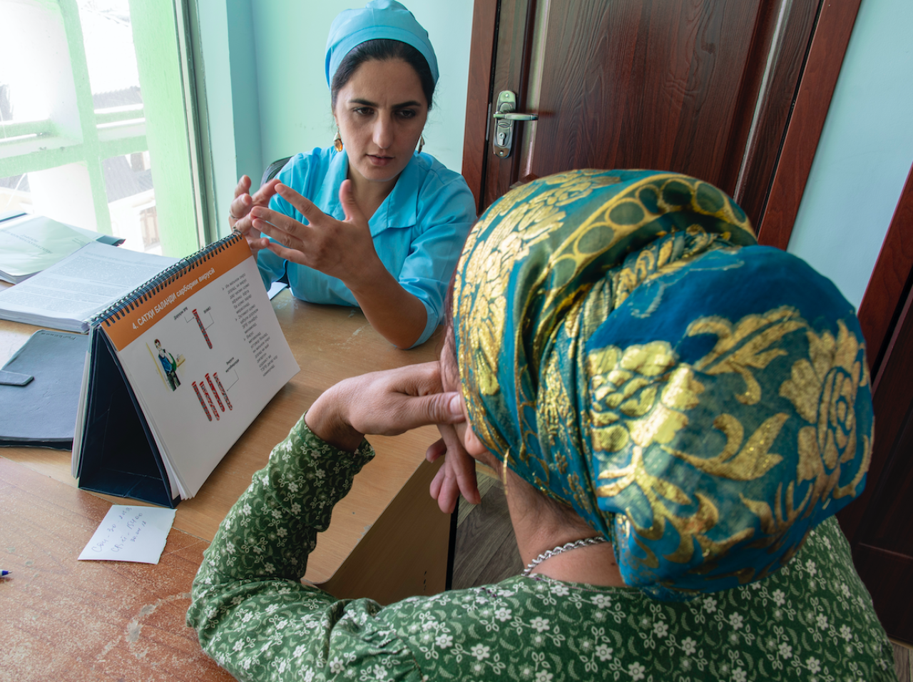 Healthcare worker speaks with patient