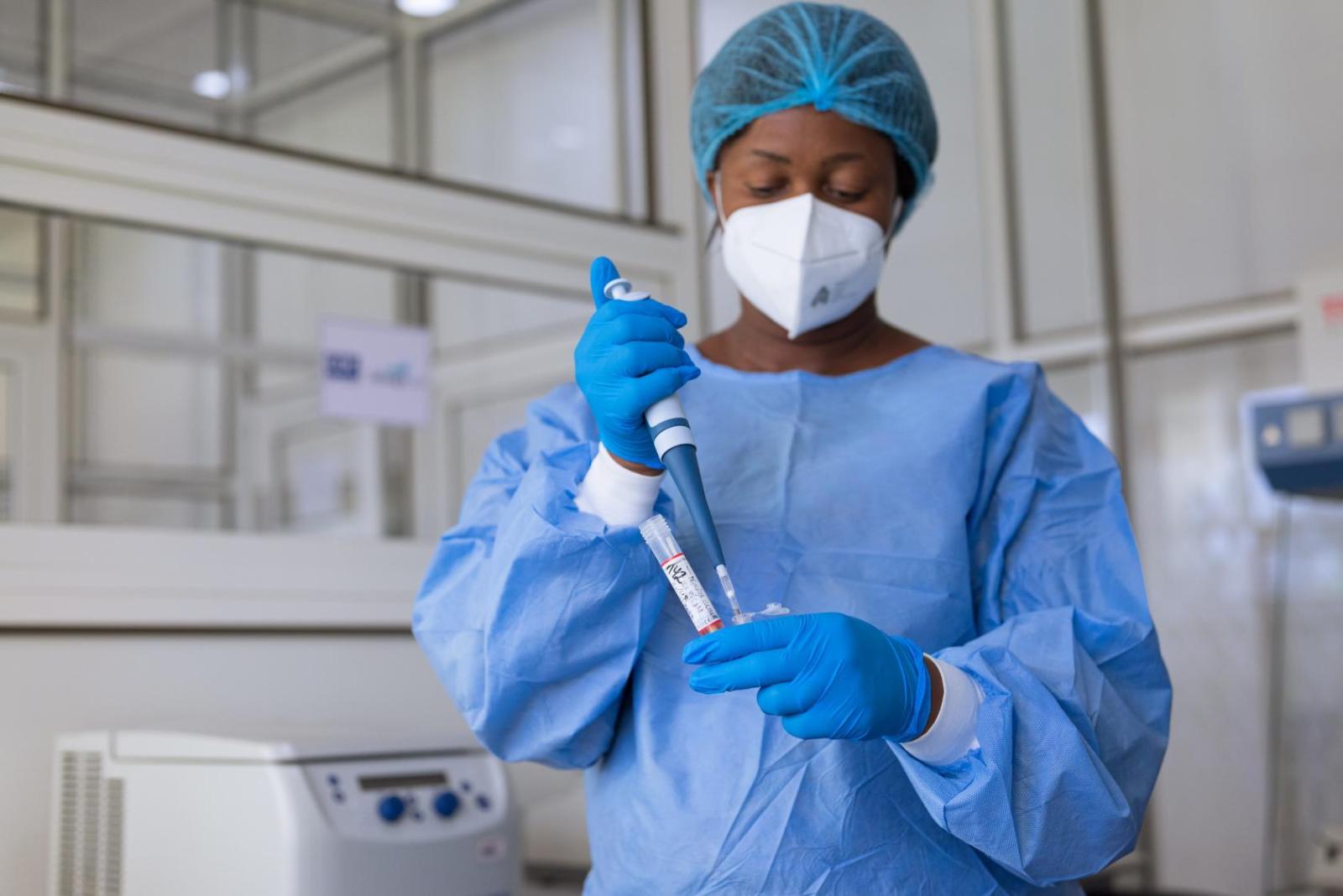 Lab technician holds performs extraction