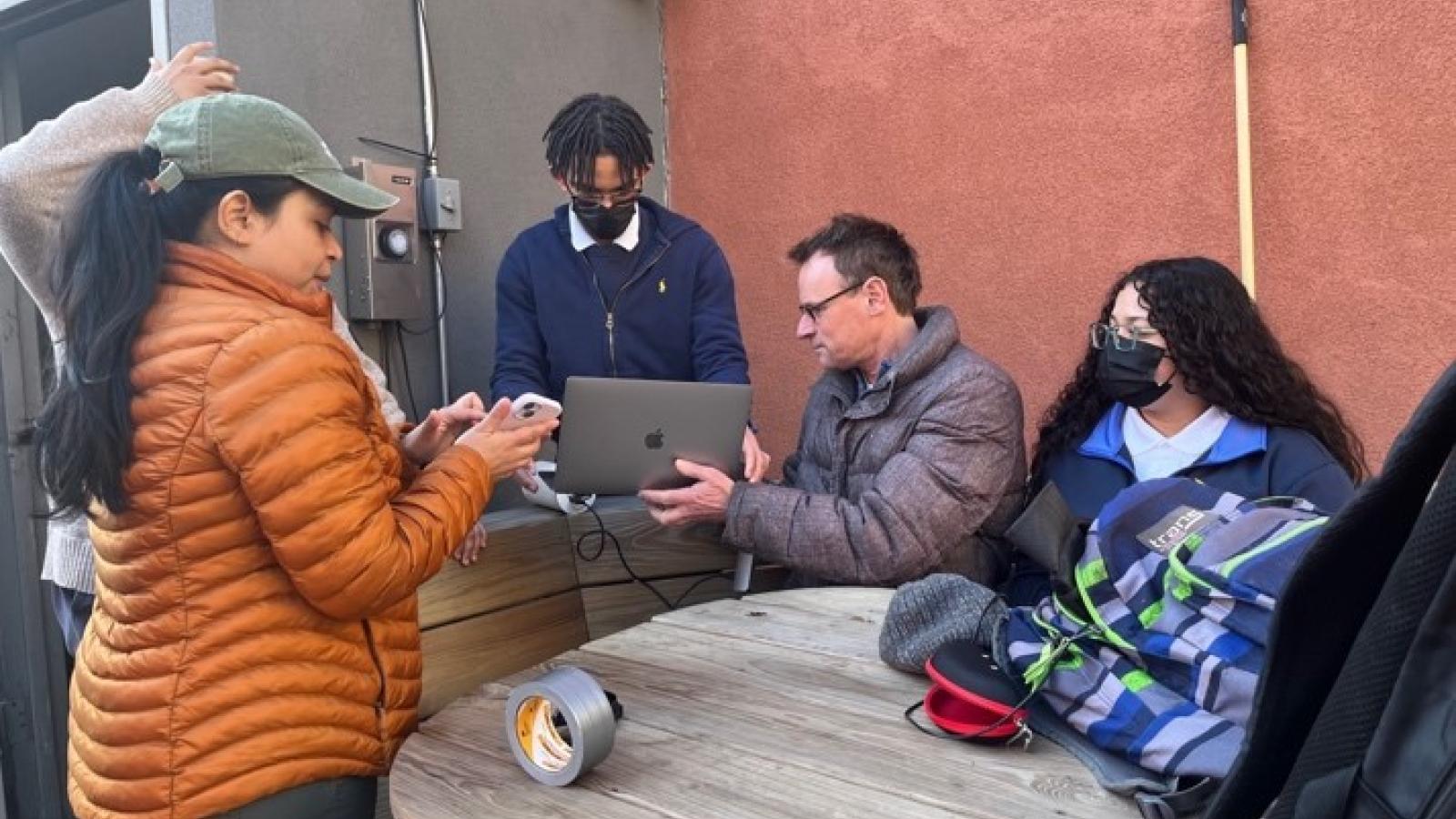 Markus Hilpert and Yoshira Ornelas Van Horne set up air monitors with high school students in the Bronx