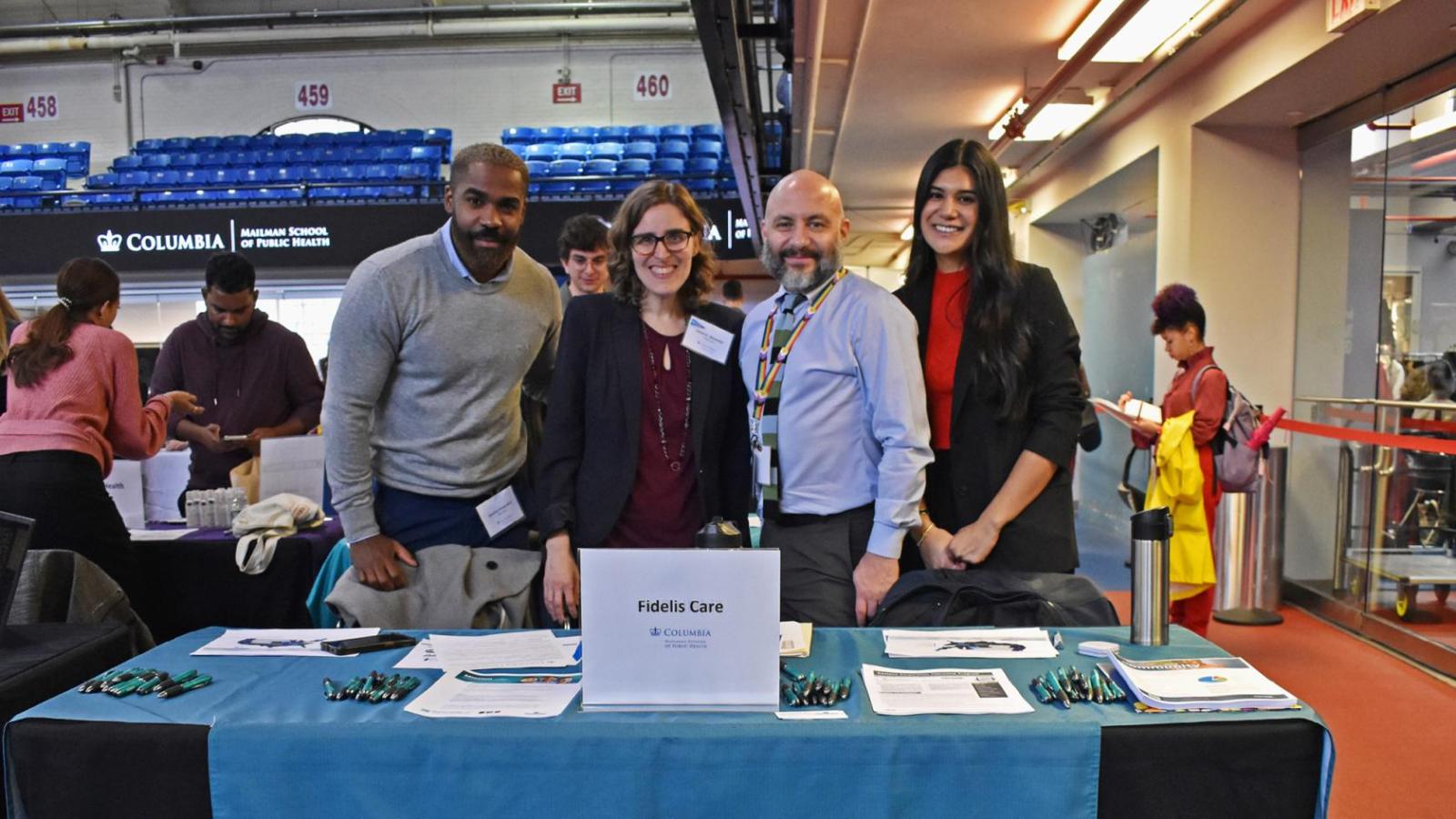 Representatives from Fidelis Care pose near table