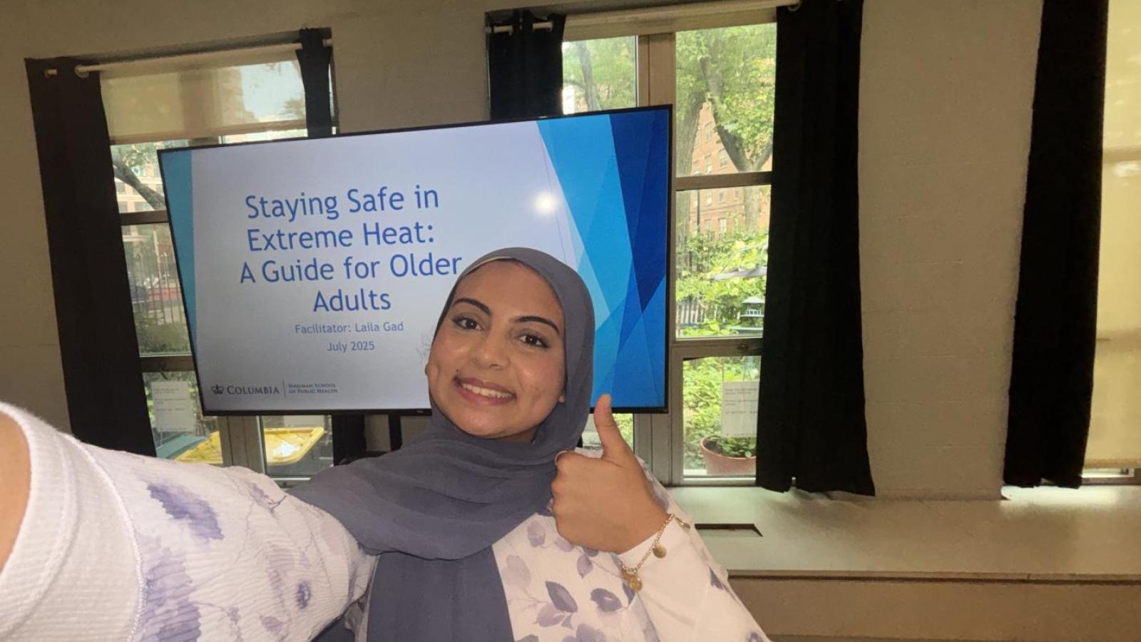 Student stands in front of a presentation on a screen titled "Staying Safe in Extreme Heat"