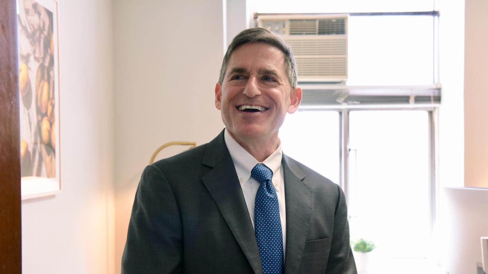 A smiling man looks up