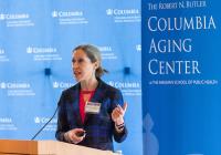 A woman speaks at a podium