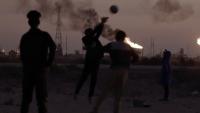 Gas flares and children playing