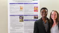 ICAP's Next Generation students standing in front of research poster.