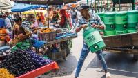 Water is delivered at an Ahmedabad market. Before 2010, residents worked through extreme heat. Today, they take more precautions.