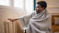 cold man beside a radiator