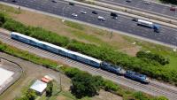 A highway and a passenger train from above