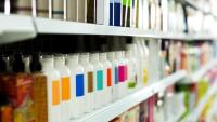 A store shelf with bottles of beauty products