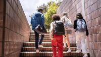 A photo of four young people walking up stairs