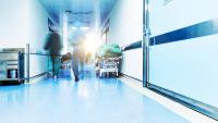 Doctors or nurses walking in hospital hallway, blurred motion