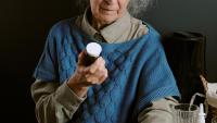 elderly woman holding bottle of Benzodiazepine