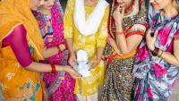 Global women in festive dress holding menstruation product