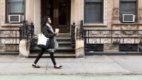 Pregnant woman walking on urban street