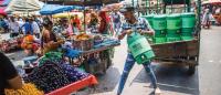 Water is delivered at an Ahmedabad market. Before 2010, residents worked through extreme heat. Today, they take more precautions.