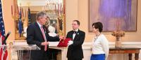 Ambassador Laurent Bili bestows the Insignia of the Chevalier of the Légion d'Honneur  to Dean Linda P. Fried as an attendant holds the Insignia on a red pillow. Photo: Nassereen Mirza