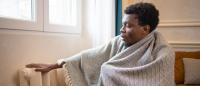 cold man beside a radiator