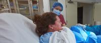 woman giving birth assisted by health providers