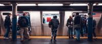 A group of people waiting to get onto a subway in New York City