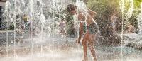 Child cools off in jets of water