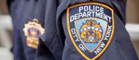 Photo of NYPD badge on torso of police officer