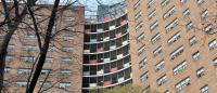 View of rounded red-brick apartment building from a low angle