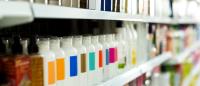 A store shelf with bottles of beauty products