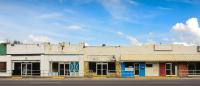 A photo of abandoned stores along a highway