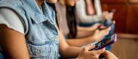 A group of young people holding cell phones