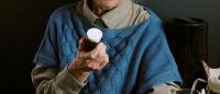 elderly woman holding bottle of Benzodiazepine