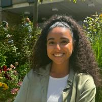 Cherine Jaafar standing in front of flowers