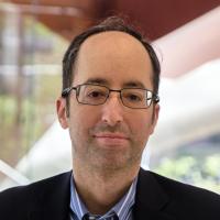 Timur Pakay headshot in a lobby on campus