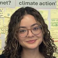 Woman wearing glasses and has curly hair