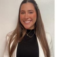 Woman with long hair smiling.